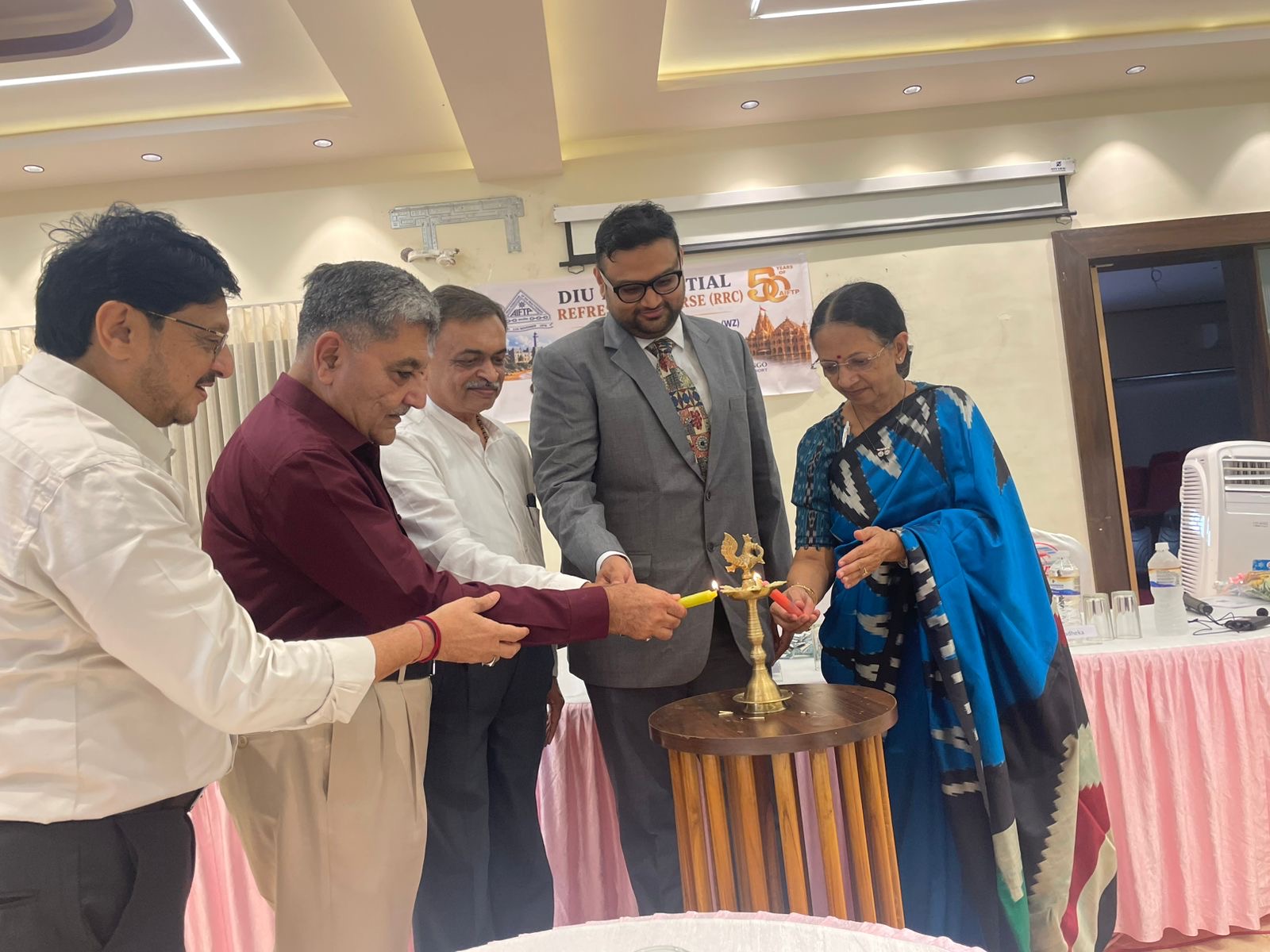 Smt. Nikita R. Badheka, Past President, AIFTP inaugurating the conference by lighting of lamp. Also seen from left to right S/Shri Adv. Sanjaybhai Tanna, President, Gir-Somnath Tax Bar Association, Samir S. Jani, Past President, AIFTP, Bhaskar B. Patel, Past Treasurer, AIFTP and Akshay Modi, Chairman, AIFTP (WZ).