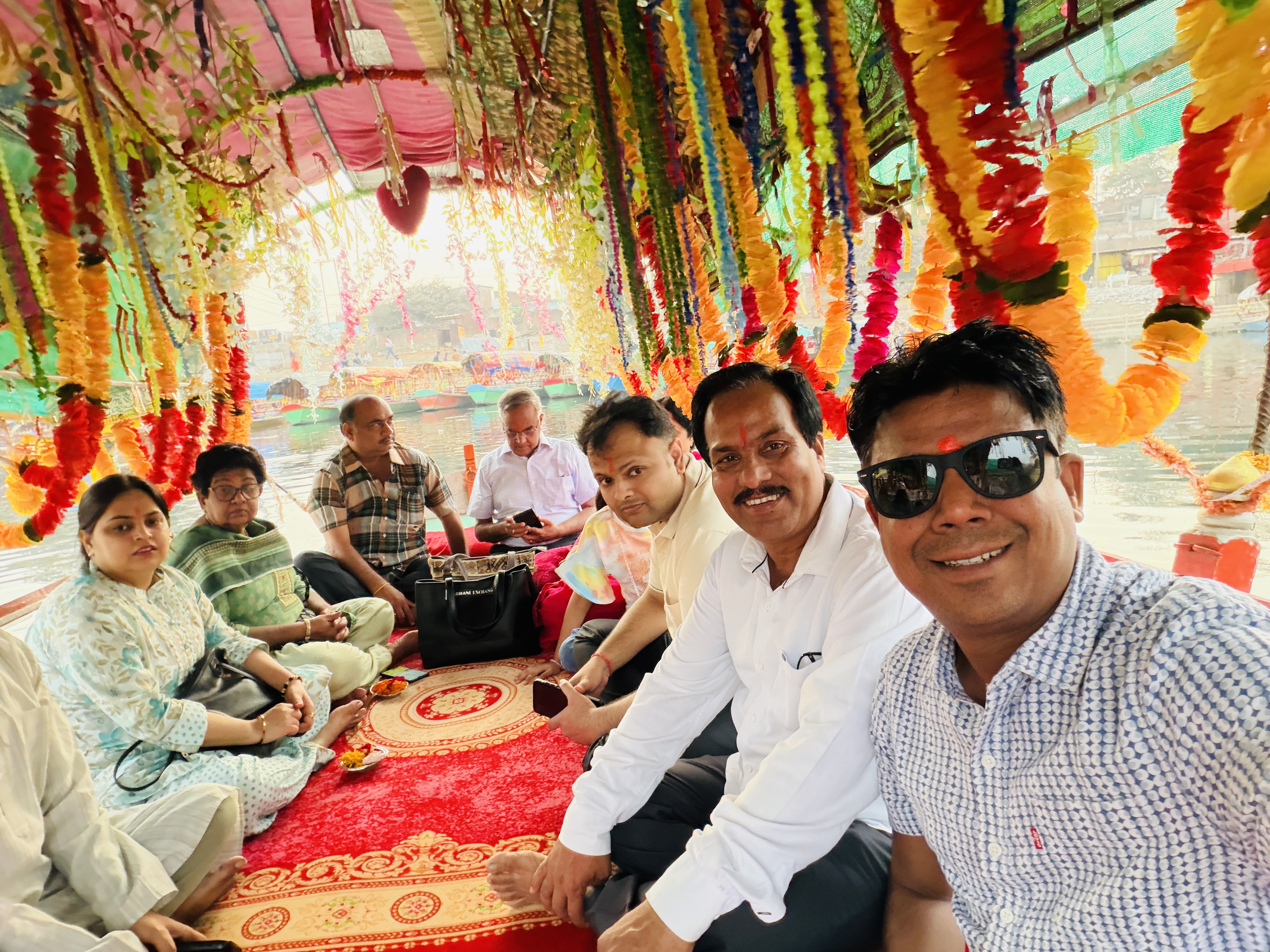 Delegates experiencing the mesmerising Aarti at Ram Ghat, viewed from beautifully adorned and illuminated boats on the sacred Mandakini River, creating a serene and devotional ambience.